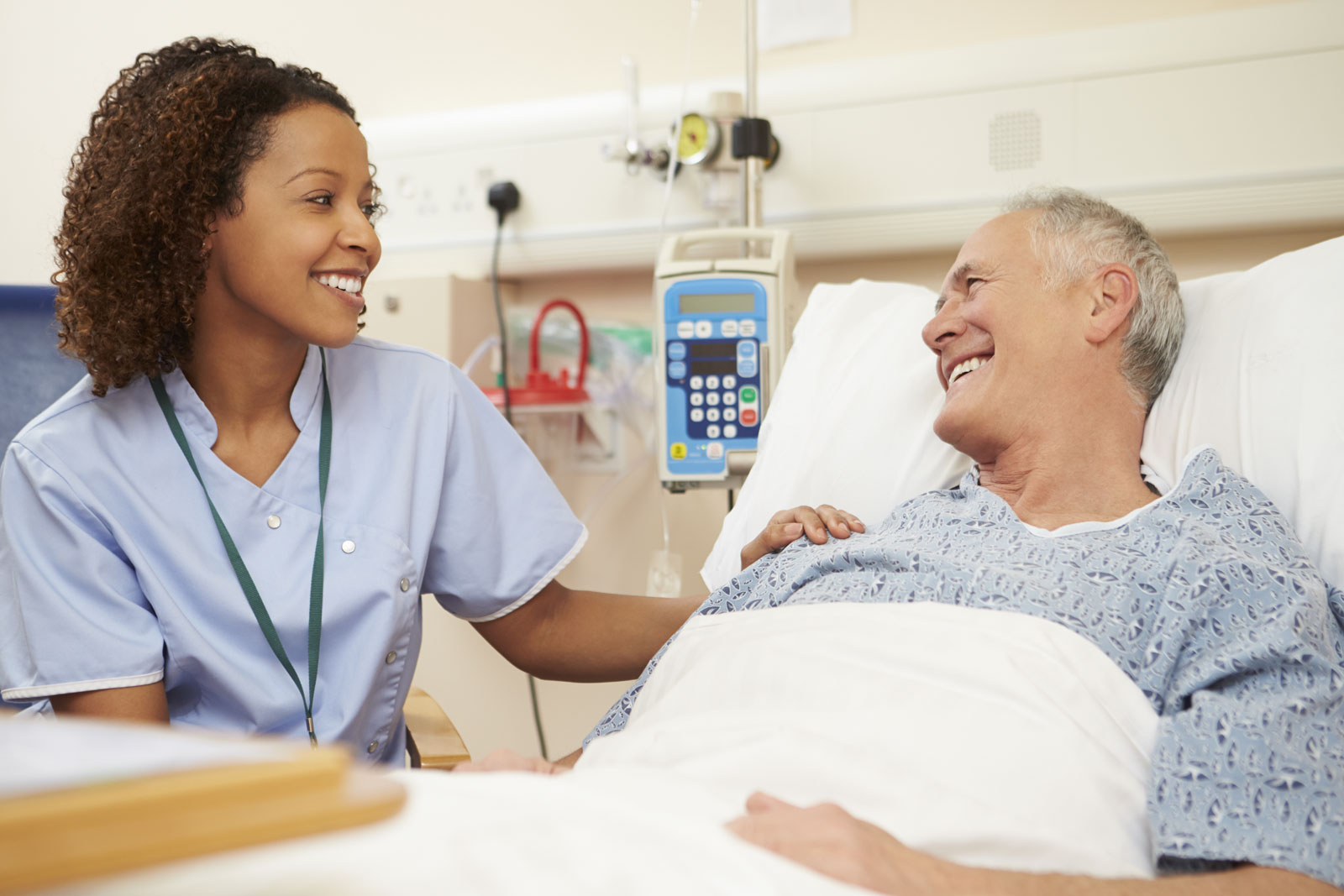 nurse talking to patient in hospital bed