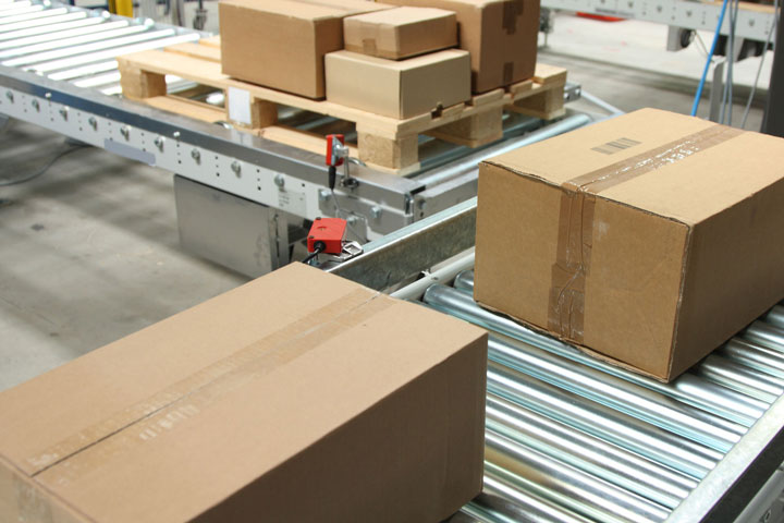 image of boxes on a conveyor belt, warehouse technology installed by St. Onge
